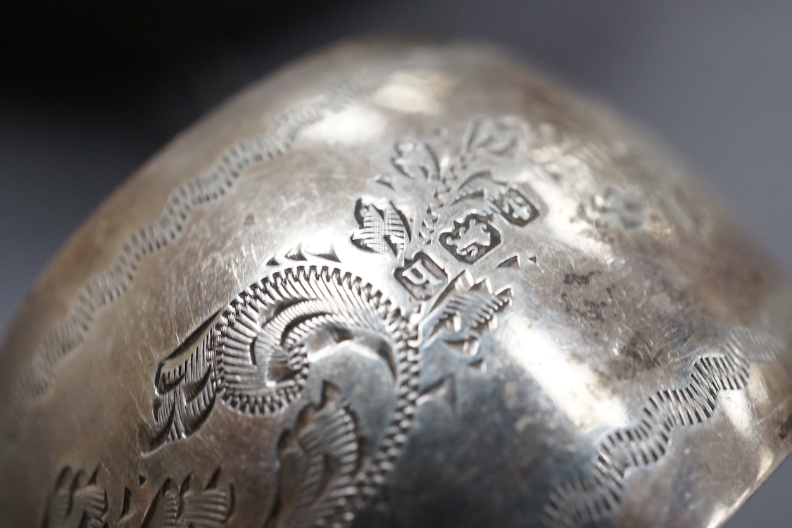 A George V silver sauceboat, with flying scroll handle, Jay, Richard Attenborough Co Ltd, Sheffield, 1925, together with a set of four Edwardian silver napkin rings, 11.3oz.